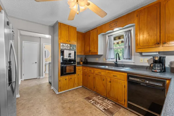 a kitchen with stainless steel appliances granite countertop a refrigerator and a sink