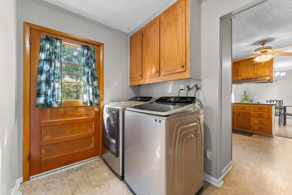 a utility room with cabinets dryer and washer