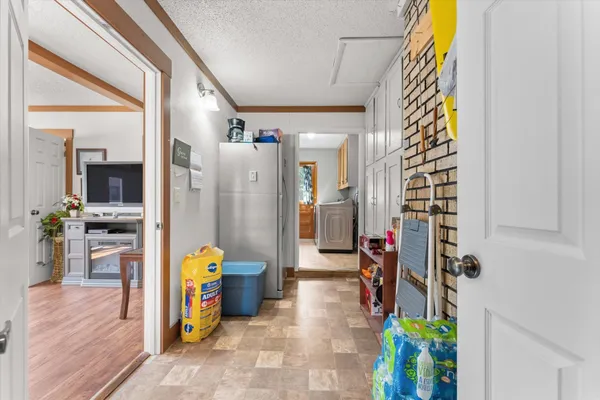 a view of a hallway with dining area and glass door