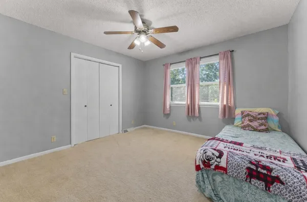 a bedroom with a bed and a large window
