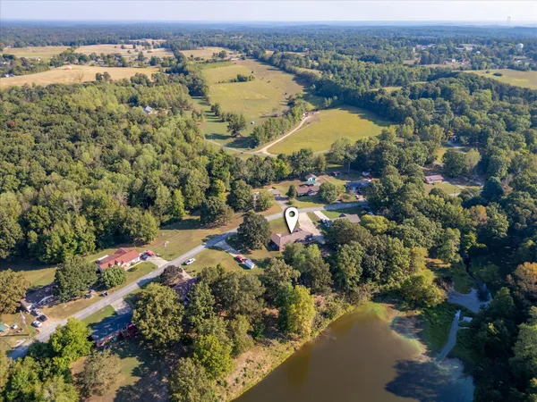 an aerial view of lake and residential houses with outdoor space