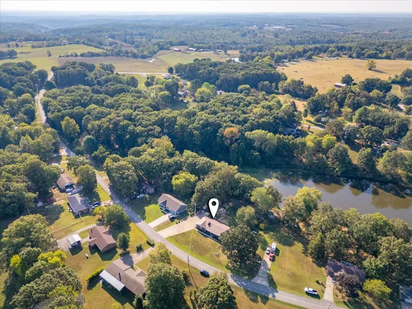 an aerial view of a house with yard
