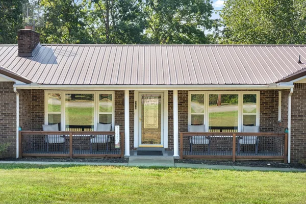 a view of a house with a backyard and a patio