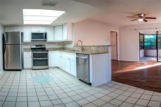 a kitchen with stainless steel appliances cabinets a sink and a stove