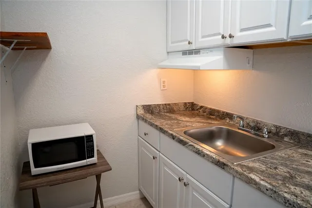 a kitchen with a sink and a microwave