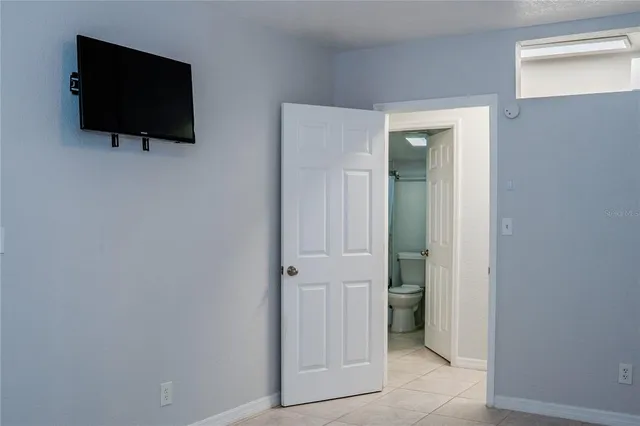 a living room that has a flat screen tv and a wall painting