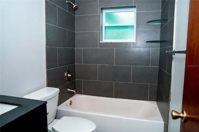 a bathroom with a bath tub and a window