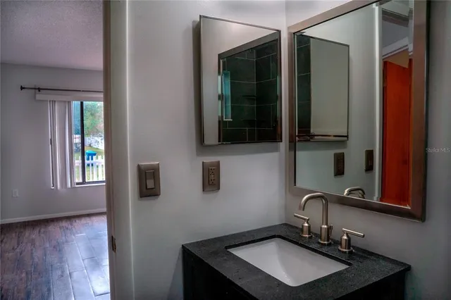 a bathroom with a sink and a mirror