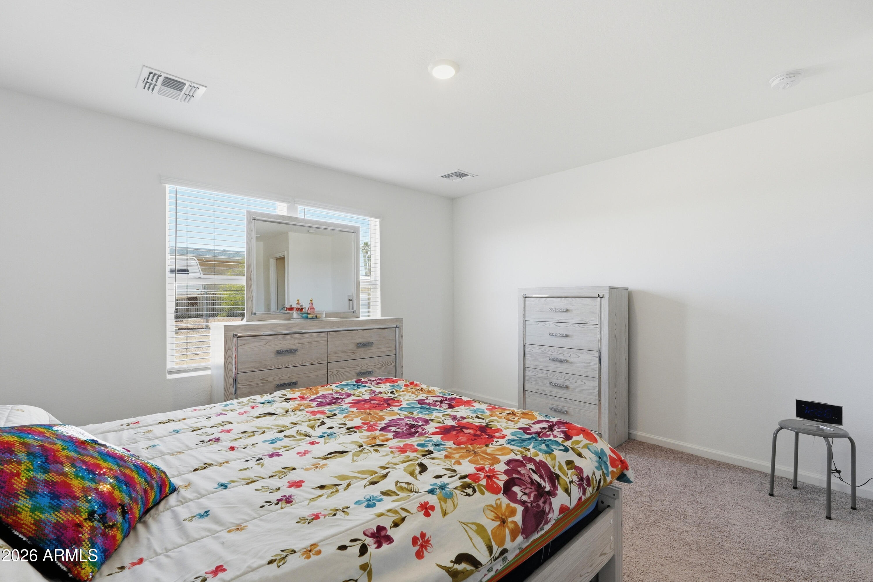 15610 South Moon Valley Road Arizona City, AZ 85123 - Photo 18 of 36 a bedroom with a bed and a dresser in it