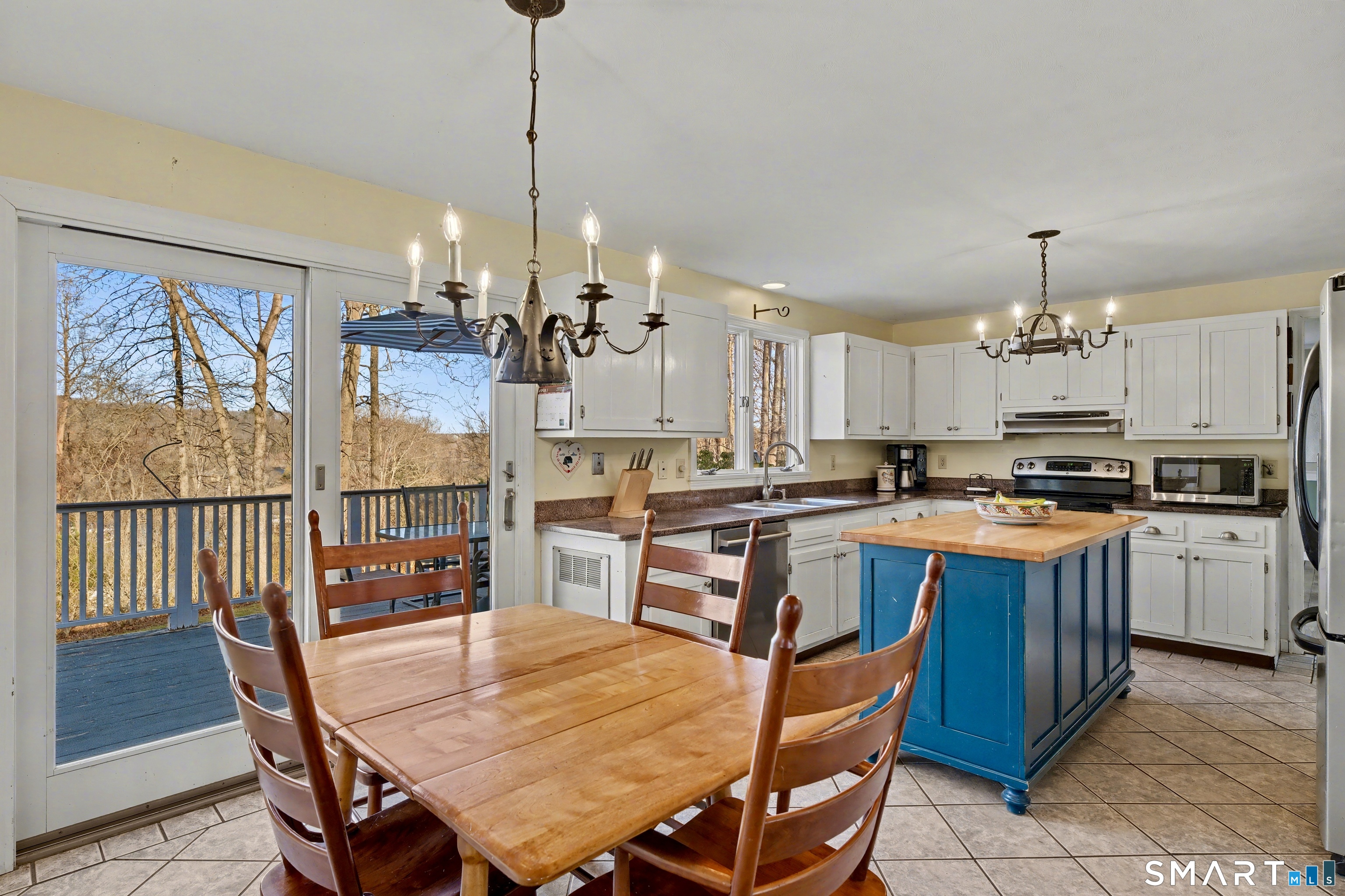 226 Middlesex Avenue Chester, CT 06412 - Photo 14 of 40 a kitchen with stainless steel appliances granite countertop a kitchen island a stove a table and chairs