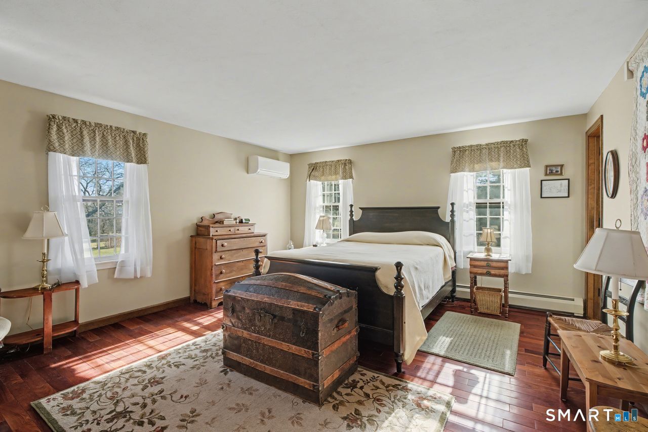 226 Middlesex Avenue Chester, CT 06412 - Photo 19 of 40 a bedroom with a bed a table and chair