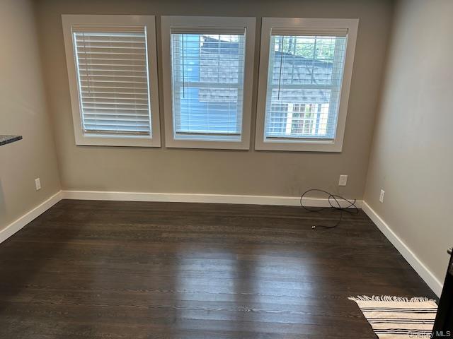 377 Fort Salonga Road Northport, NY 11768 - Photo 2 of 5 an empty room with wooden floor and windows