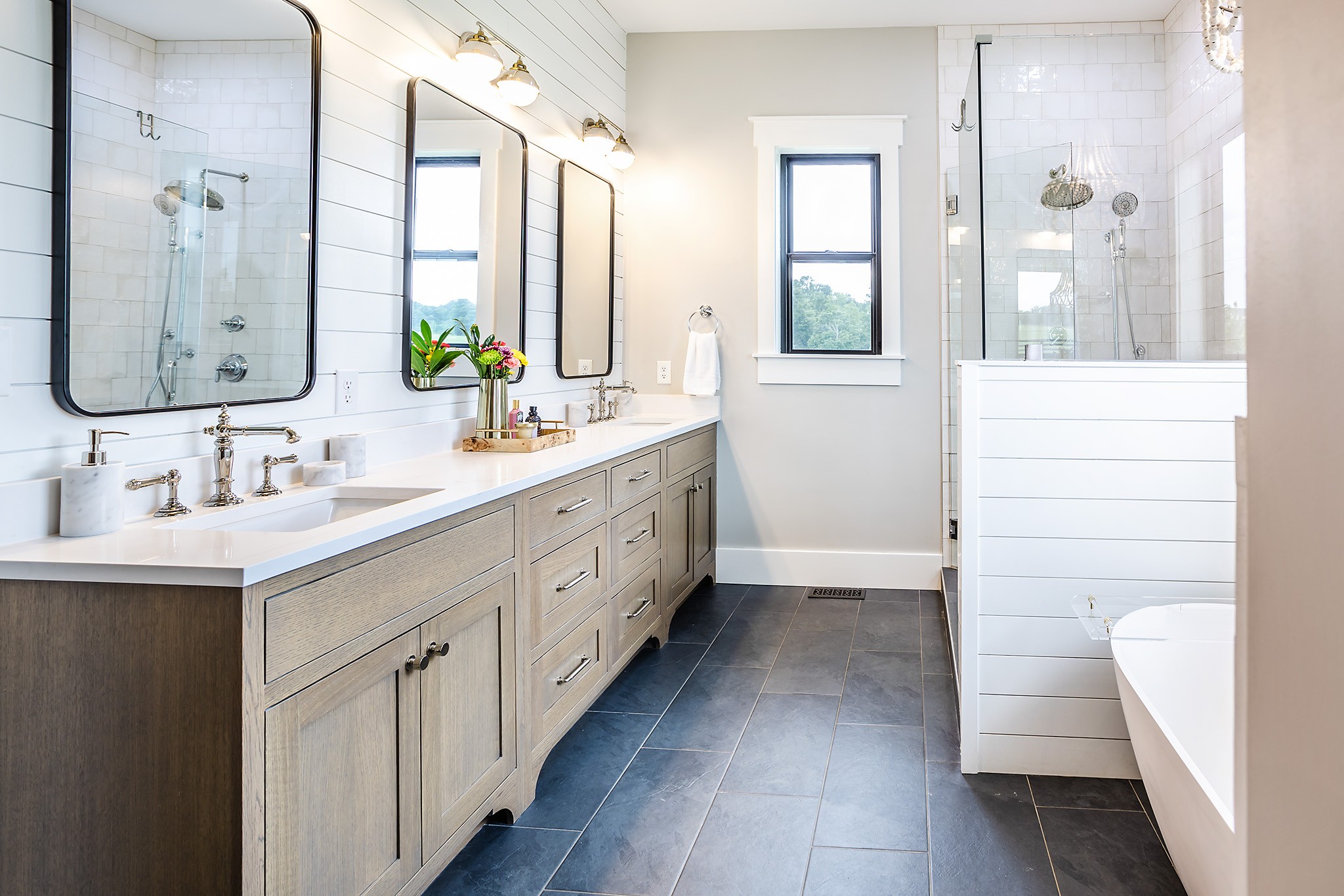 1143 Maxwell Branch Road Cottontown, TN 37048 - Photo 29 of 64 a bathroom with a double vanity sink a mirror and a bathtub