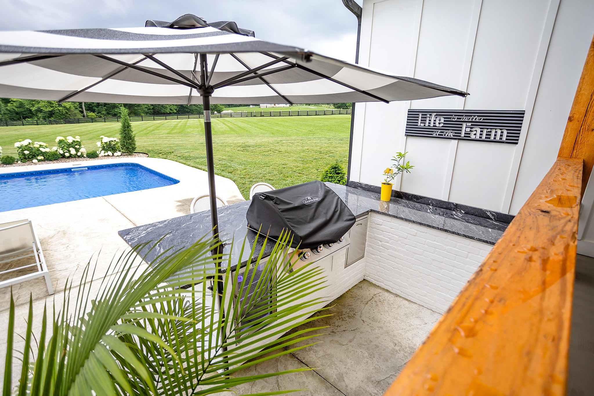 1143 Maxwell Branch Road Cottontown, TN 37048 - Photo 54 of 64 a roof deck with table and chairs under an umbrella