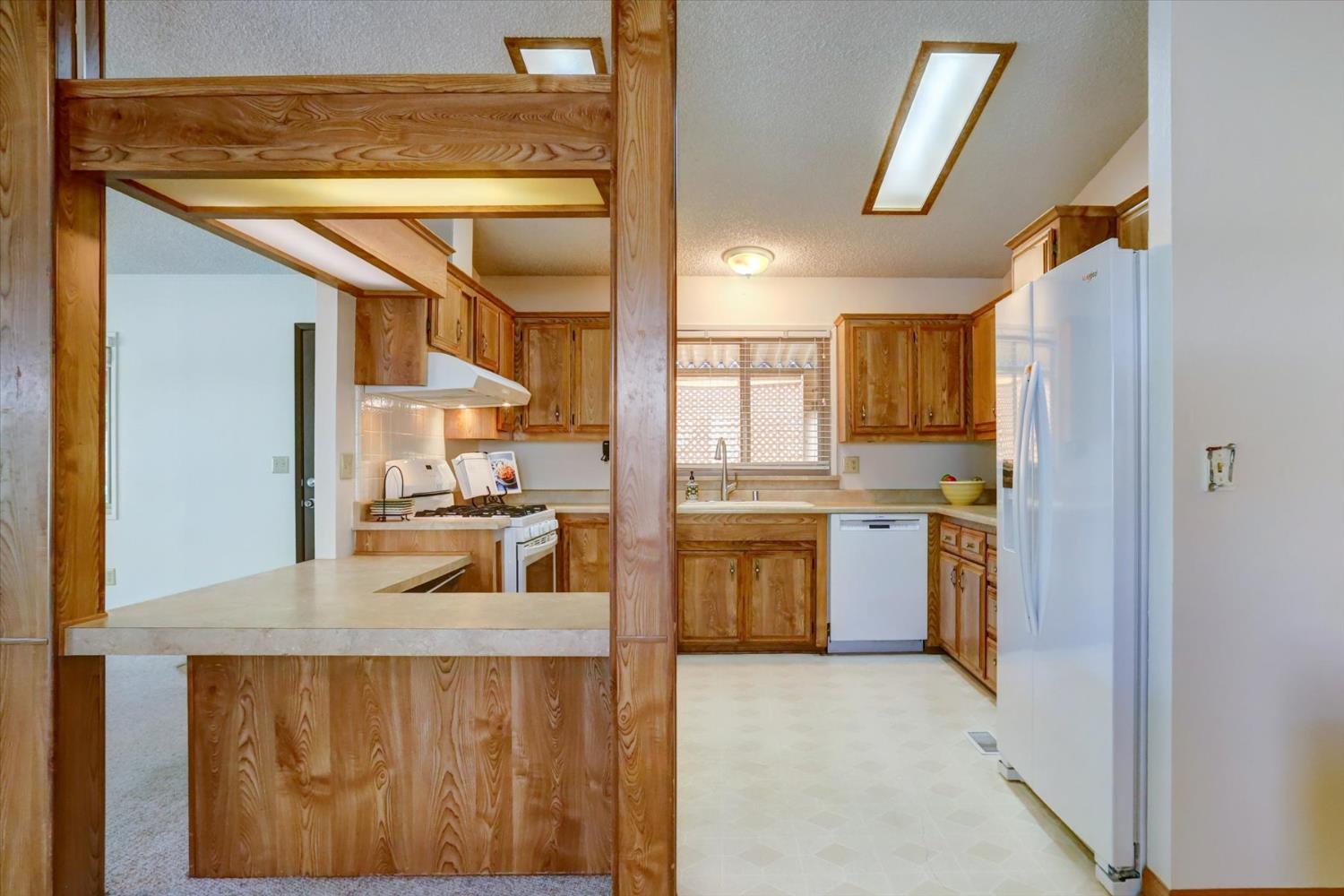 10046 Dalewood Way Grass Valley, CA 95949 - Photo 14 of 68 a kitchen with kitchen island sink stove and refrigerator