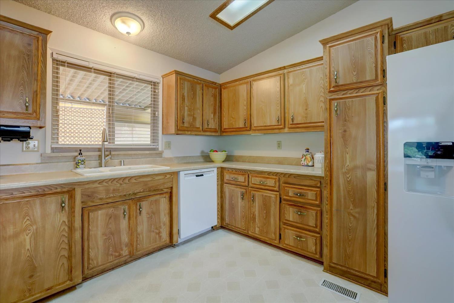 10046 Dalewood Way Grass Valley, CA 95949 - Photo 17 of 68 a kitchen with sink cabinets and window