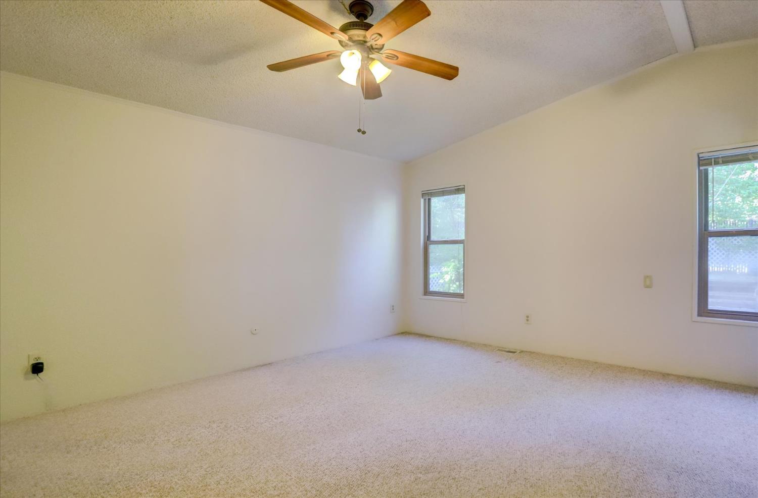 10046 Dalewood Way Grass Valley, CA 95949 - Photo 19 of 68 an empty room with windows and fan