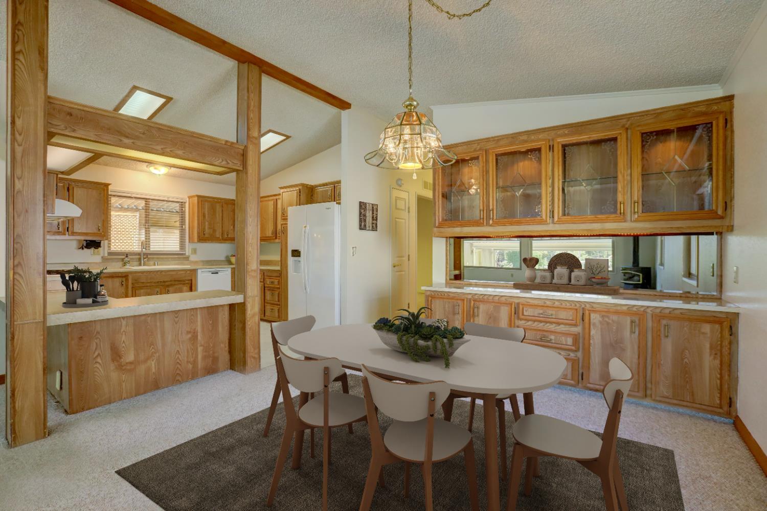 10046 Dalewood Way Grass Valley, CA 95949 - Photo 6 of 68 a dining room with stainless steel appliances kitchen island granite countertop a dining table chairs and a refrigerator