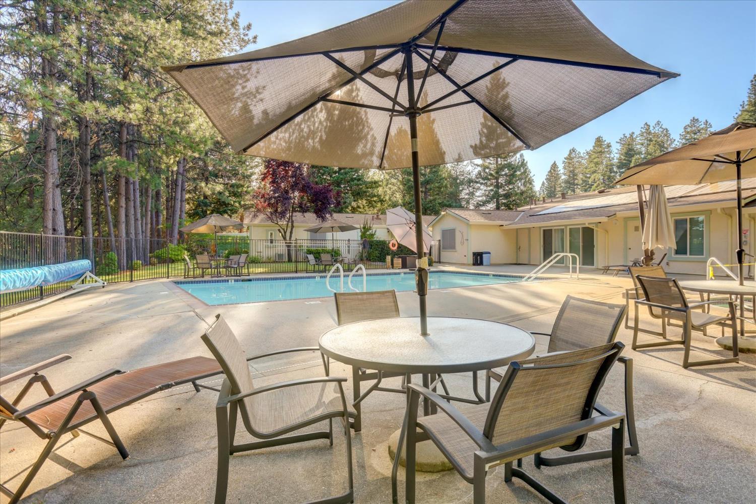 10046 Dalewood Way Grass Valley, CA 95949 - Photo 65 of 68 a patio table with chairs and umbrella