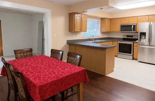 a kitchen with a stove a sink and a refrigerator