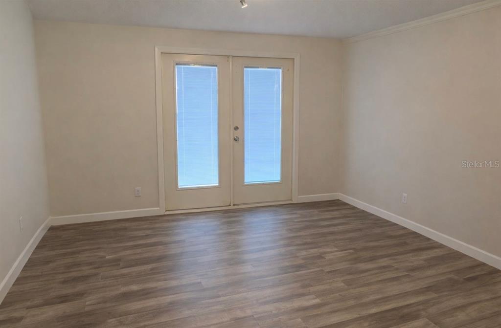 2320 Palm Avenue Seffner, FL 33584 - Photo 13 of 15 a view of an empty room with wooden floor and glass door