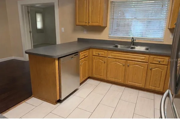 a kitchen with stainless steel appliances granite countertop a sink and a cabinets