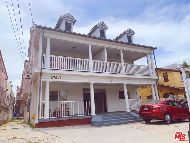 a front view of a house with parking space