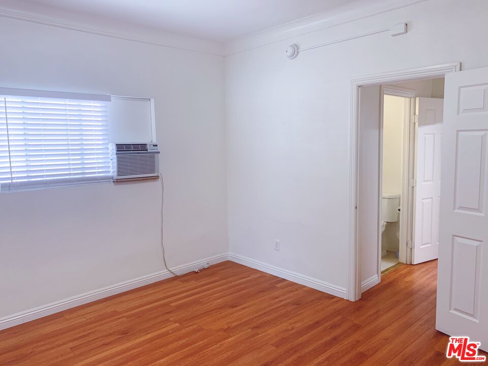 2740 James M Wood Boulevard Los Angeles, CA 90006 - Photo 11 of 15 a view of empty room with wooden floor