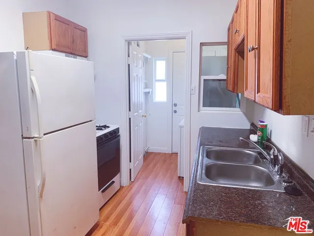 a kitchen with a refrigerator sink and stove