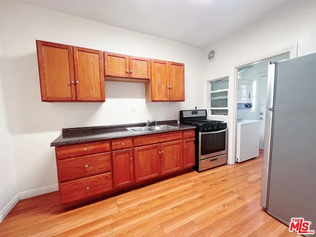 a kitchen with granite countertop wooden cabinets and stainless steel appliances