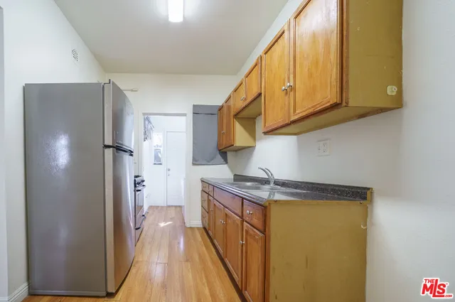 a kitchen with stainless steel appliances granite countertop a refrigerator and a stove