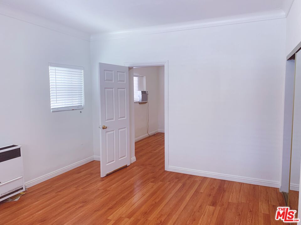 2740 James M Wood Boulevard Los Angeles, CA 90006 - Photo 9 of 15 a view of an empty room with wooden floor