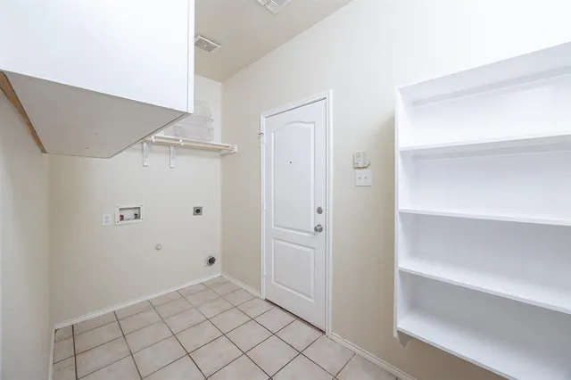 a view of an empty room with floor to ceiling windows