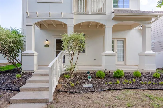 an empty room with windows and ceiling fan