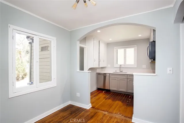a kitchen with kitchen island granite countertop white cabinets and stainless steel appliances