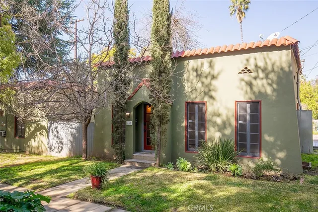 a view of a house with a yard and tree s