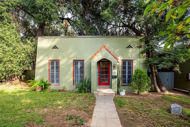 a view of white house with a yard and plants