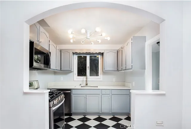 a kitchen with stainless steel appliances granite countertop a stove and a sink