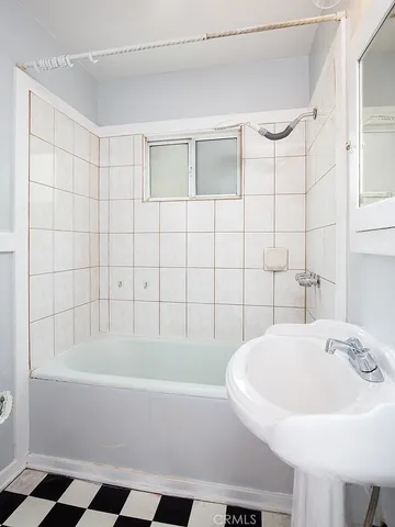 a bathroom with a bathtub and a sink