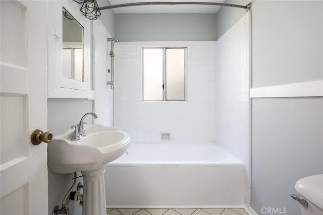 a bathroom with a sink a toilet and bathtub