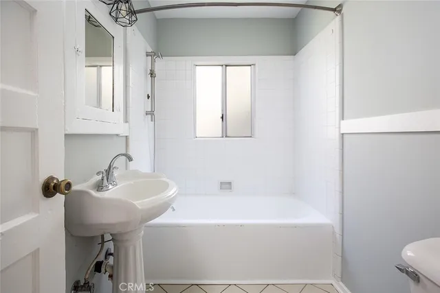 a bathroom with a sink a toilet and bathtub