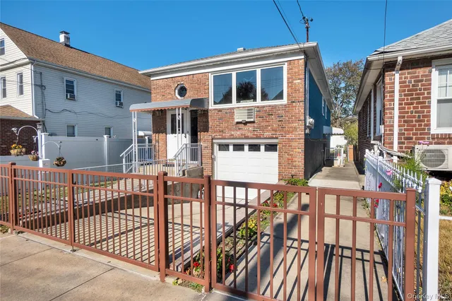 a view of a house with wooden deck and furniture