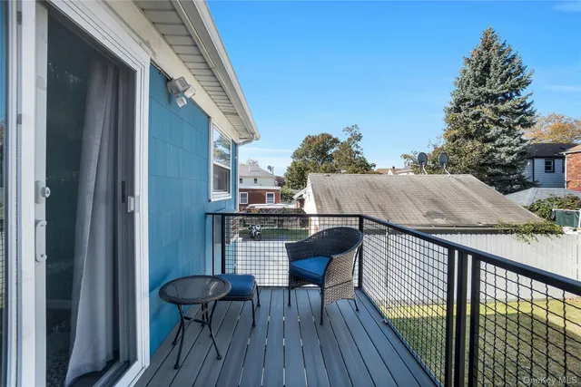 a balcony with table and chairs
