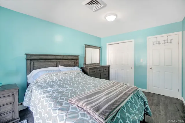 a bedroom with a bed and a dresser