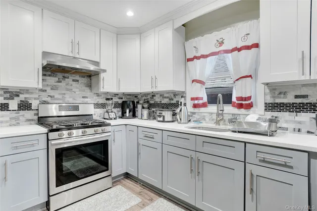 a kitchen with cabinets appliances and a sink