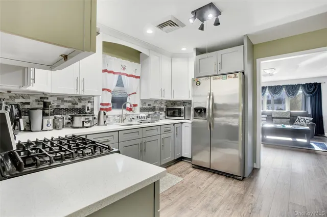 a kitchen with stainless steel appliances a refrigerator sink and stove