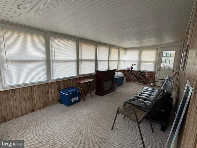 a living room with furniture a window and a chandelier