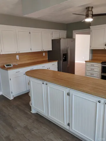 a kitchen with granite countertop white cabinets and sink