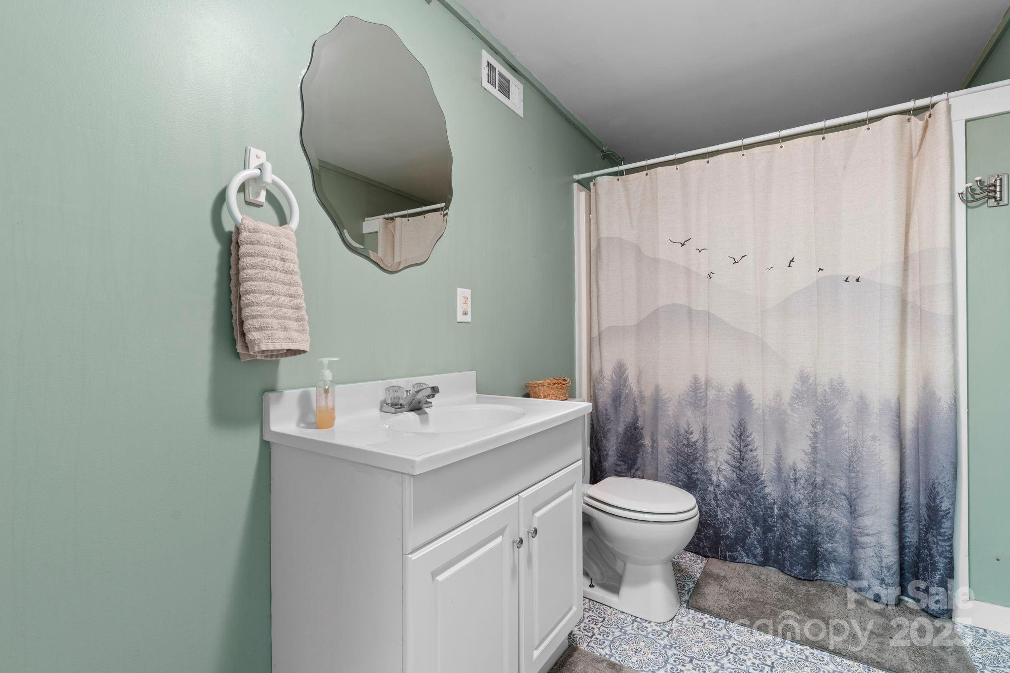 211 Granite Ridge Nebo, NC 28761 - Photo 33 of 43 a bathroom with a toilet sink and mirror