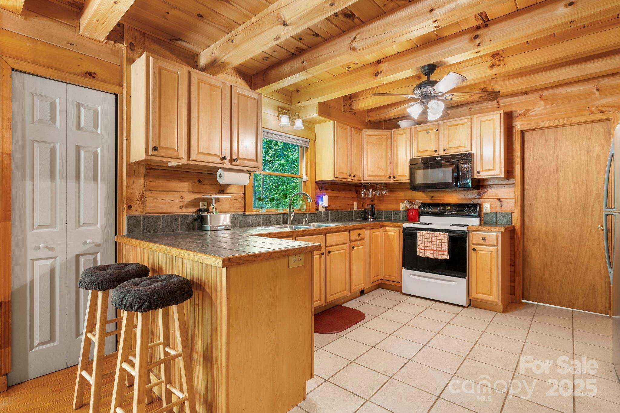 211 Granite Ridge Nebo, NC 28761 - Photo 9 of 43 a kitchen with stainless steel appliances granite countertop a stove a sink and a refrigerator